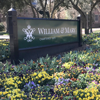 William and Mary campus sign surrounded by spring flowers.