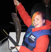 Alex Gade ’08 with a giant fish she caught in Norway.