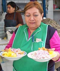 Doña Mary, serving ceviche in a popular market, is one of the many who went from food stand owner to successful entrepreneur.