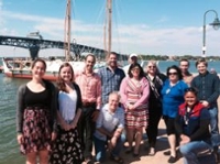 Members of the Food-Energy-Water workshop group in front of the Hokulea at berth in Yorktown.