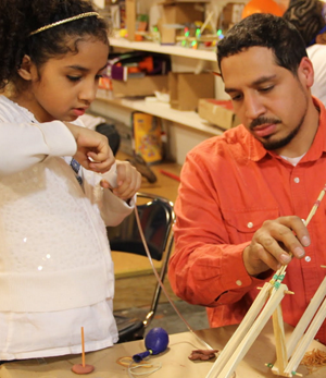 A student receives hands-on help from an engineer. Image courtesy of Iridescent.