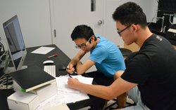 Cedar Ren (left) and John Liu work on the predictive, computational aspects of the ''biomathy'' project.