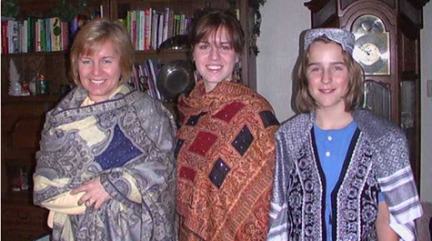 Marna and her children wearing clothing sent to them from Afghanistan