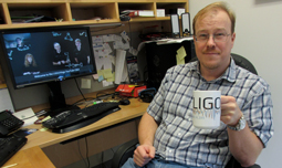 Eugeniy Mikhailov takes a celebratory sip from his LIGO mug after watching the NSF webcast.