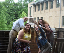 Education students take a selfie with the School of Education's bell during a scavenger hunt designed to help them get to know the building. (Photo courtesy of the W&M School of Education)