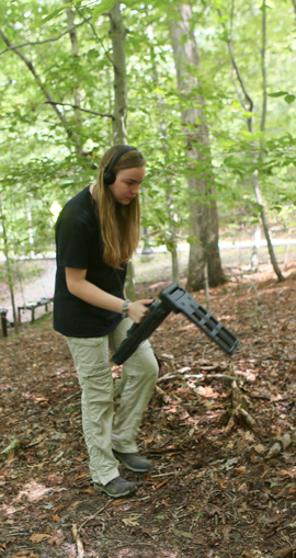 Olivia Windorf listens for a signal relayed from the transponder-toting toad. Her apparatus can detect toads a meter or so underground. (Photo by Stephen Salpukas)