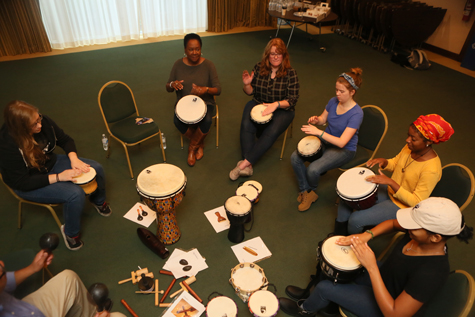 Students participate in a drum circle. (Photo by Stephen Salpukas)
