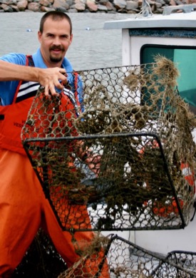 Dave Stanhope, CCRM research manager, handles a derelict or “ghost” crab pot recovered from the York River. (Photo by D. Malmquist/VIMS)