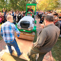 Steve Prince drives the steamroller over the first woodcut block panel. (Photo by Stephen Salpukas)