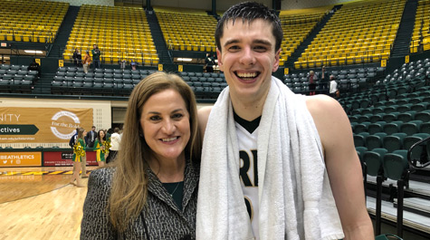 Huge with men's basketball captain Paul Rowley after Senior Day win over UNC-Wilmington