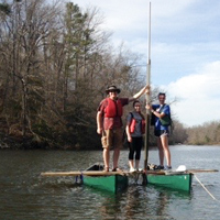geologist Jim Kaste works with a couple of William & Mary undergraduates from a coring platform assembled from a couple of lashed-together canoes on Lake Matoaka.