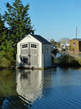 An amphibious shed rises with floodwaters in the VIMS Boat Basin. (VIMS photo)