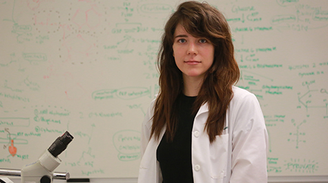 Portrait photograph of Eden Maness in the lab wearing a lab coat