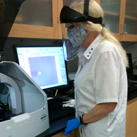 Amy Wilkerson checks out the Dektak XT surface profiler in one of William & Mary’s Applied Research Center core labs