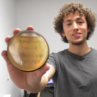 Paul Volante shows how a petri dish of honey sits atop a gamma detector 