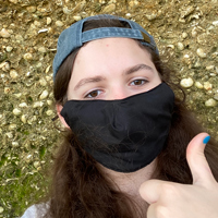 Student wearing mask gives thumbs up