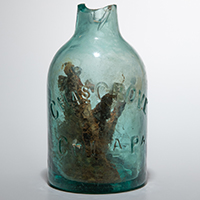 Glass jug filled with nails that is believed to be a rare ritual item known as a “witch bottle."