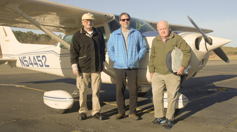 Fuzzzo Schermer, Bryan Watts and Mitchell Byrd stand in front of the airplane