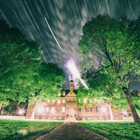 A timelapse image shows startrails above the Wren Building at night