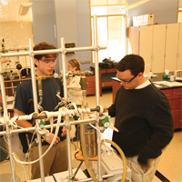 Two students using lab equipment.