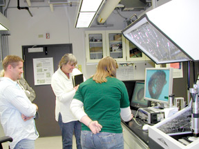 Clustered around the HIROX microscope in the Surface Characterization Lab are (from left) archeobotanist Steve Archer, Paula Neely of National Geographic and research technician Natalie Pearcy.