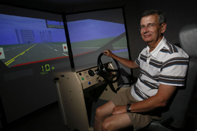 Lou Rossiter, Director, Community Research shows off driving simulator used to provide Williamsburg area residents free driving evaluations. Photo credit: Stephen Salpukas, College of William and Mary.