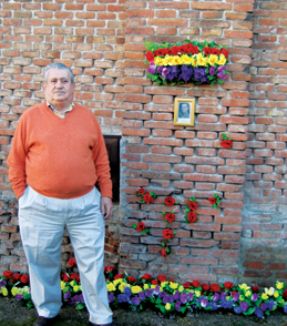 Marcos Burgos tends a shrine at the wall where his father was executed in the months following the Spanish Civil War.