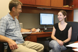 Joseph Galano, associate professor, meets with Carla Correia, first-year Psy.D. student. Galano conducts research on the prevention of child abuse and neglect, often involving students in his work. Correia is the graduate student representative on the Prevention and Promotion Advisory Council to the State Department of Mental Health.