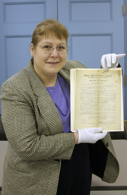 Heather Huyck displays the 1935 death certificate of Amanda Brooks. It's one of scores of documents found by the Sharpe Seminar.