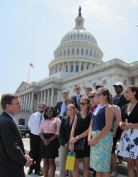 Mark Warner speaks to the community engagement fellows outside of the Captiol Building.