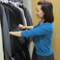 Ashleigh Brock inspects clothing available to students as part of W&M's Suits for Scholars program.
