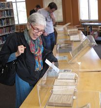  Science author Dava Sobel looks over the display of rare science books—including a first edition of Newton’s “Principia”—brought to the Physics Library from Swem Library’s Special Collection Research Center. Photo by Joseph McClain.