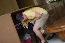 Nathan Britt pulls items out of one of the large collection boxes. Photo by Stephen Salpukas.