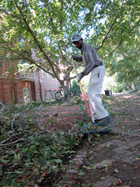 Ernest Russell cleans up storm debris after Hurricane Irene in 2011.