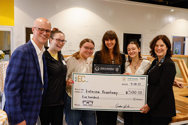 Henry Broaddus, President Rowe, Katarina Bromkamp and other students posing with an oversized check