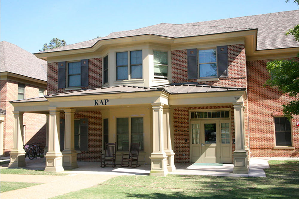 Brick fraternity house with a front porch