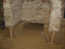 Excavation beneath foundation walls in the Brafferton's cellar.