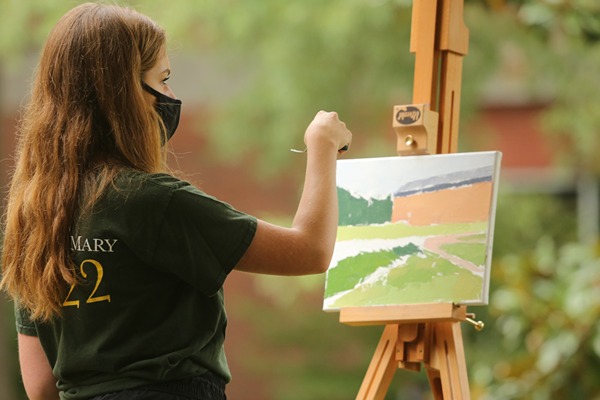 student_painting_outdoors_looking_away_right