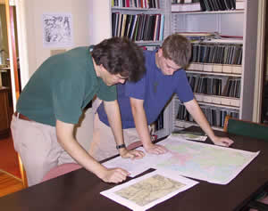 Nick Bolash (right) compares copies of Civil War era maps with a modern topographic map as part of his research.