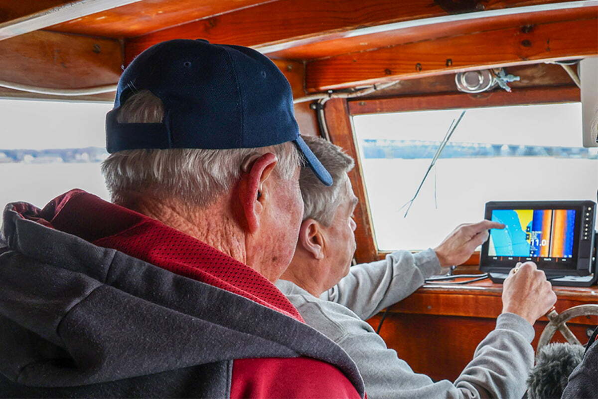E.C. Hogg (front) and Ralph Bonniville (back) gather bathymetric data.