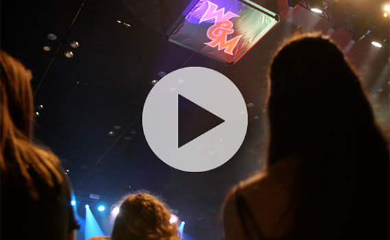 Students in Kaplan Arena looking up at a W&M Athletics mark on the roof