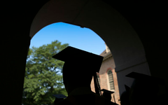 silhouette of a graduate in cap with tassle showing on the Wren Portico