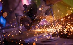 Close view of hand held stone cutting tool sending out sparks