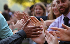 Hands high-fiving at opening convocation