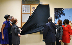 People remove curtain to unveil Trailblazers Wall