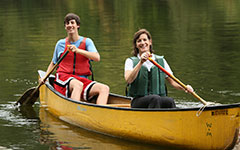 A student and family member canoeing on Lake Matoaka