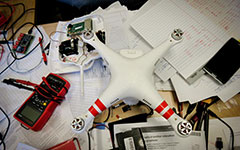 physics department’s quadcopter on a desk and loose leaf papers