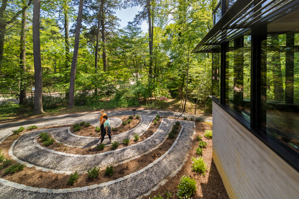 student walks through zen garden