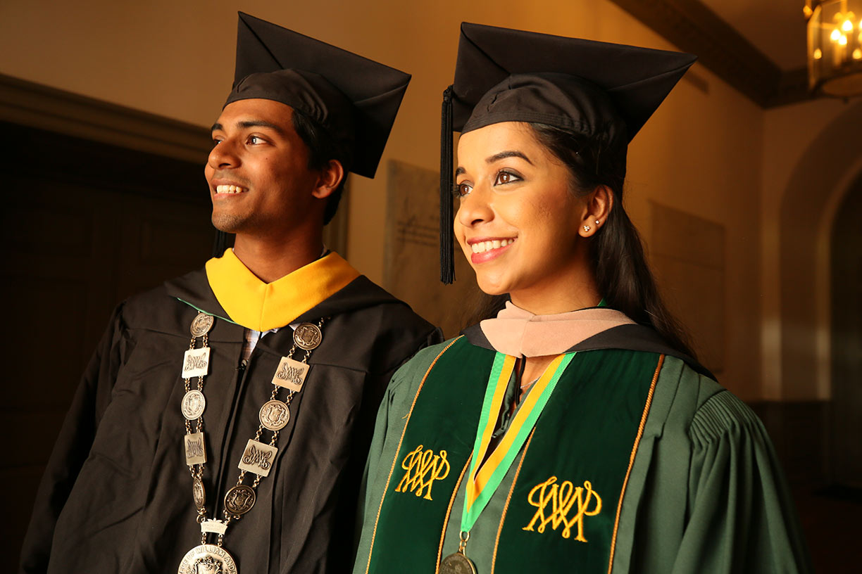 Two graduates in full regalia at Commencement including former president of the student assembly, Meghana Boojala and 