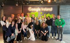 students smiling in front of "Google Ireland" sign